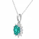 0.6ct Oval Emerald And 0.25ct Diamond Cluster Pendant In UK Hallmarked 9ct White Gold